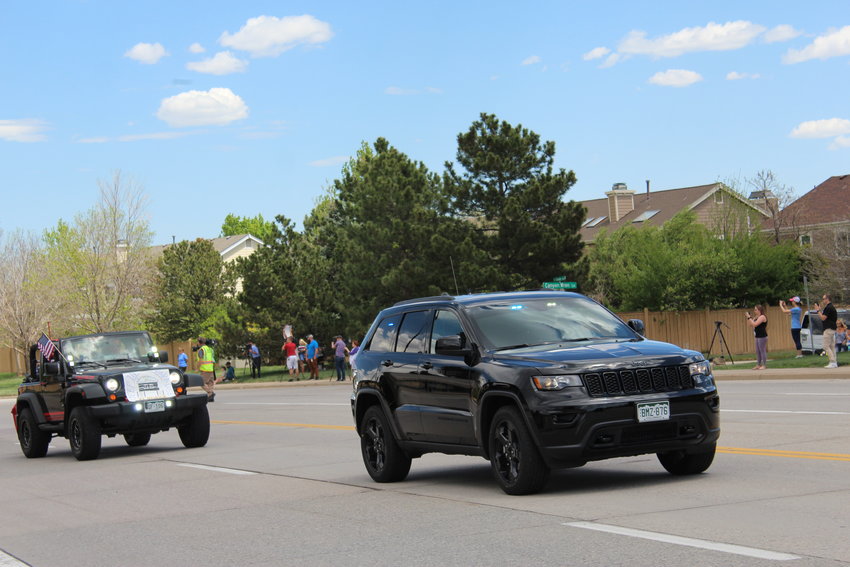 An undercover Douglas County Sheriff Jeep Cherokee leads a processional of Jeeps through Highlands Ranch to a celebration of life ceremony at Cherry Valley Community Church.